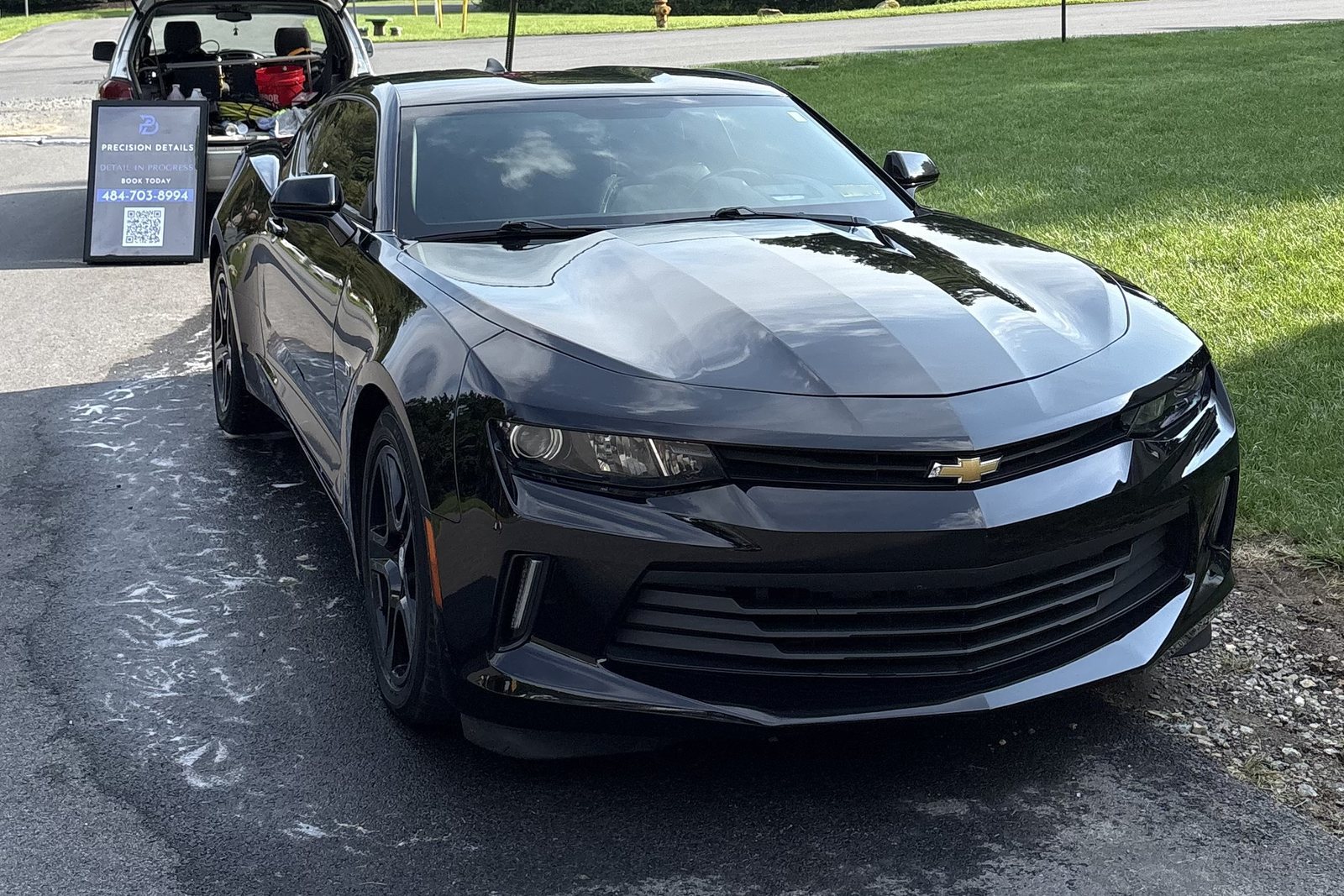 Black Chevrolet Camaro after a mobile exterior detail by Precision Details in Downingtown, PA — clay bar decontamination and hand-dried black paint with no swirl marks