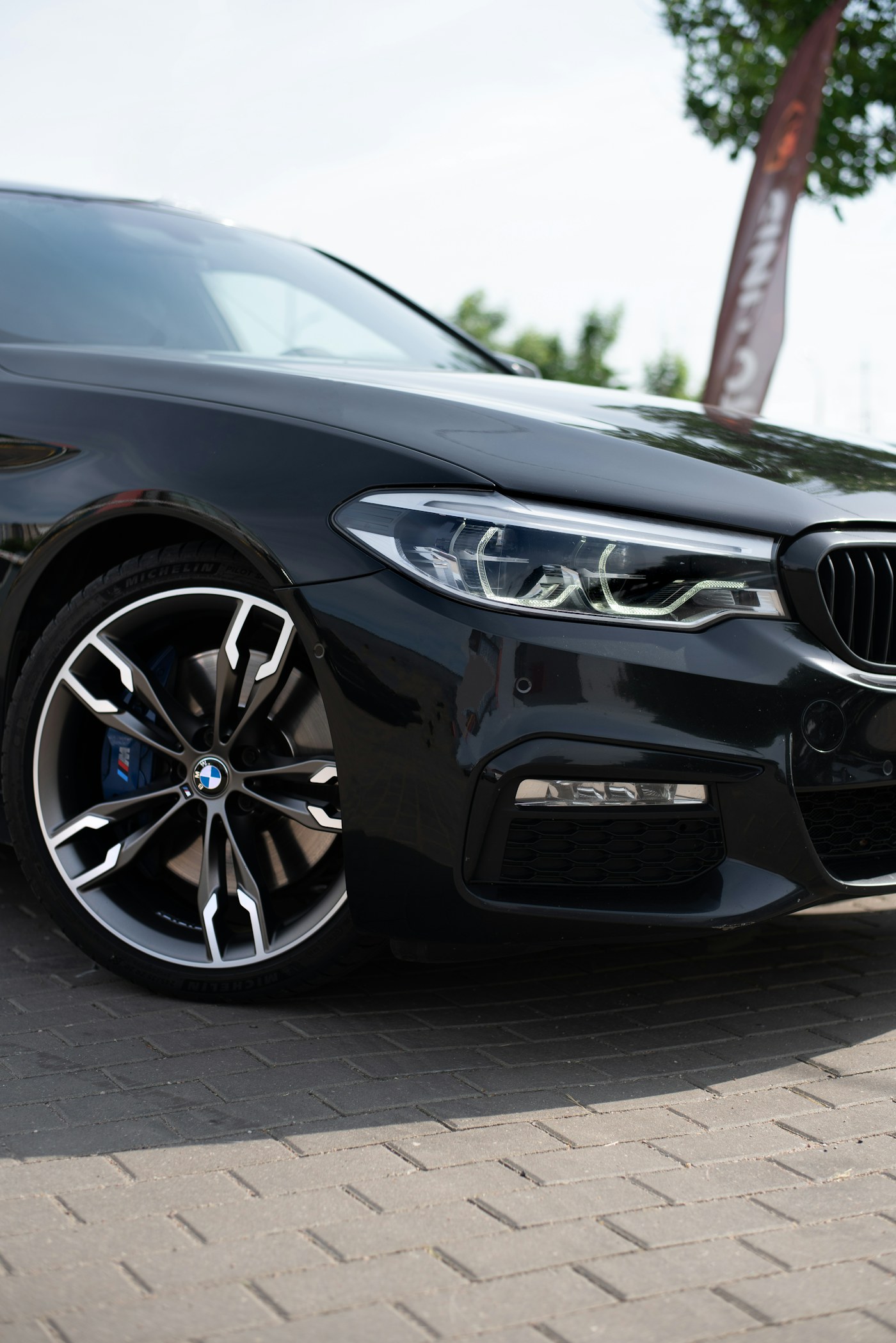 Black BMW 5 Series front quarter, polished